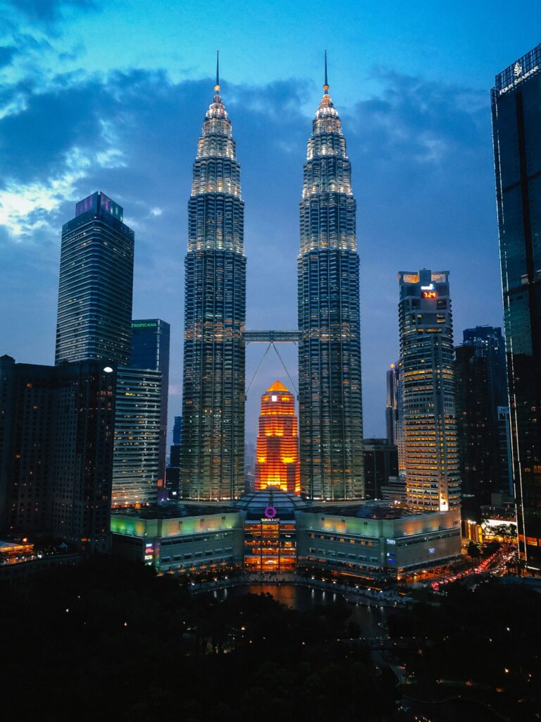 Petronas Twin Towers illuminated at night in Kuala Lumpur skyline