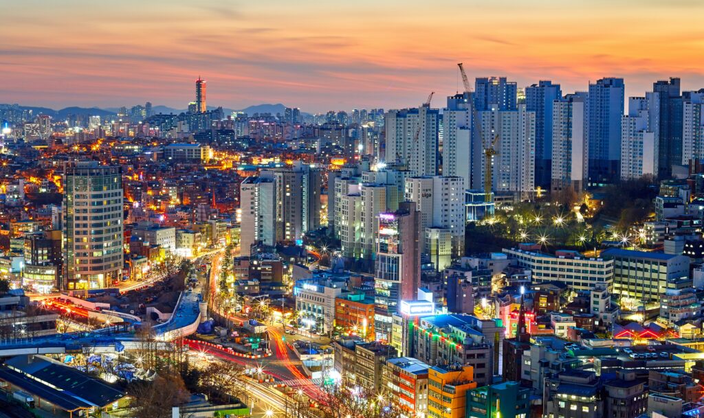 Seoul city skyline illuminated at sunset with colorful lights